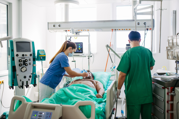 Medical team providing oxygen ventilation to unconscious patient in hospital