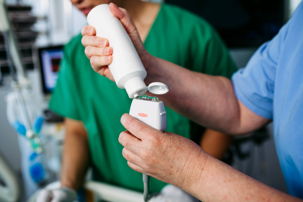 Nurse applying gel to ultrasound probe.
