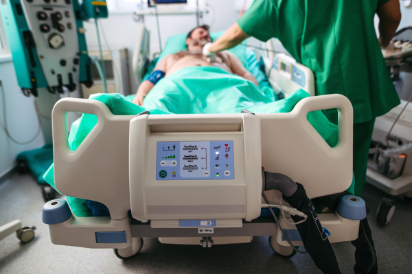 Doctor holding ultrasound transducer during abdominal ultrasound.