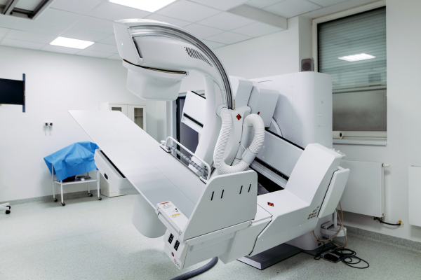 Modern tilting fluoroscopy wall unit in diagnostic imaging room