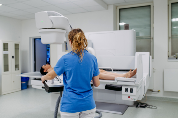 Woman having radiographic exam while lying down