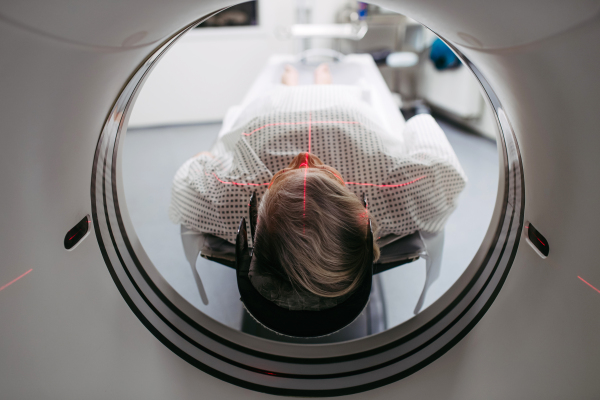 CT scanner view of senior patient during medical imaging procedure. Older woman undergoing MRI scan.