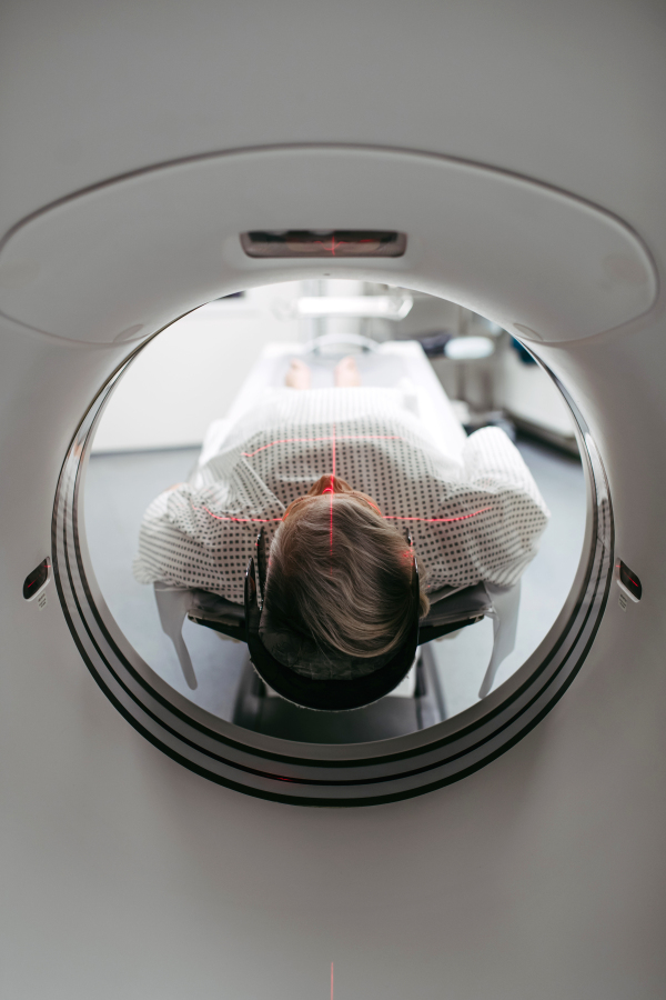 CT scanner view of senior patient during medical imaging procedure. Older woman undergoing MRI scan.