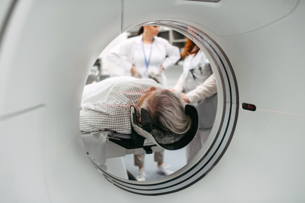 CT scanner view of senior patient during medical imaging procedure. Older woman undergoing MRI scan.