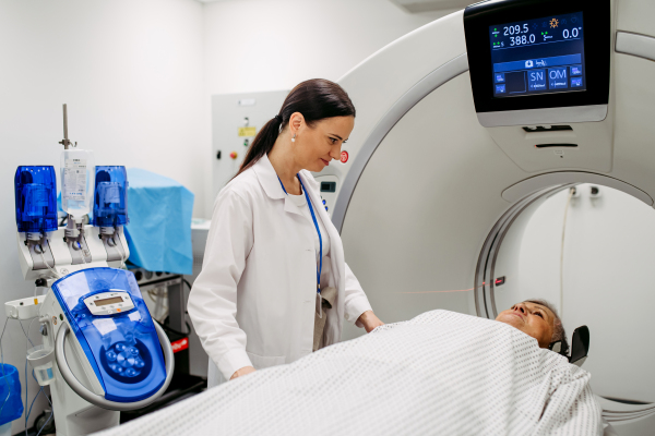 Doctor preparing senior patient for CT head scan