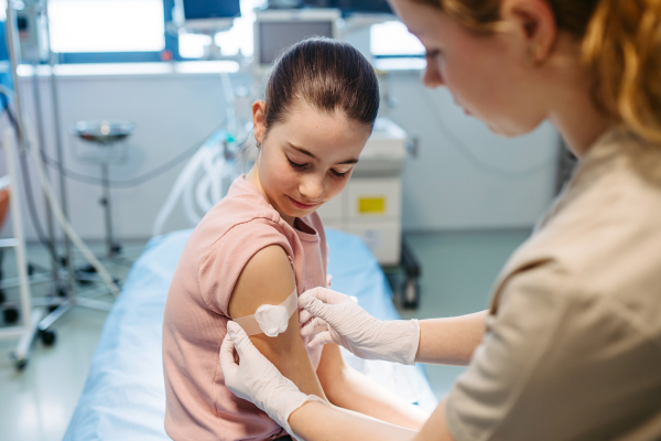 Nurse is caring for the injection wound after vaccination.