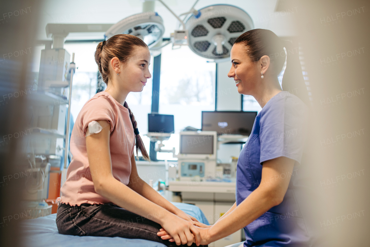 Pediatric patient talking to female doctor after vaccination.