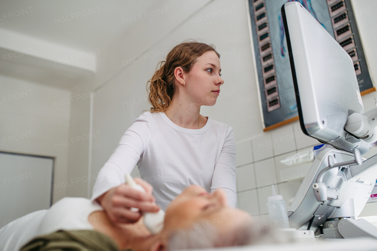 Female patient undergoing thyroid ultrasound examination. Lymp node sonography.
