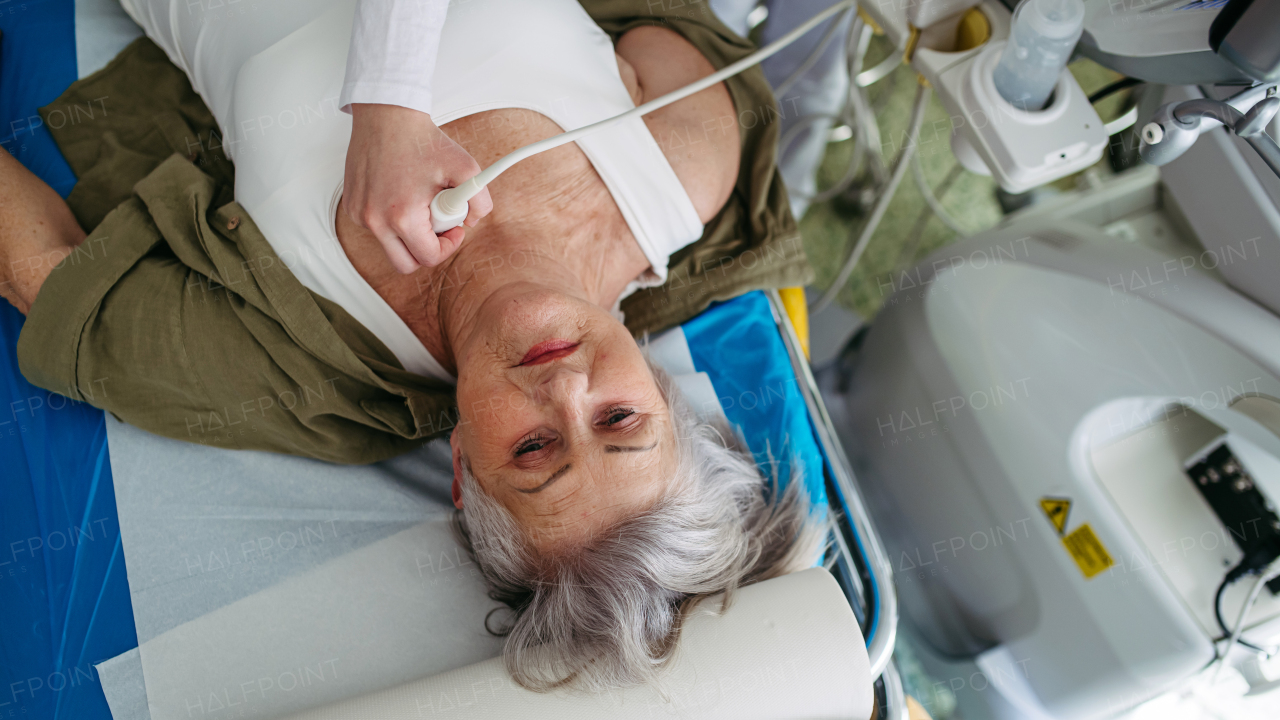 Top view of woman undergoing thyroid ultrasound examination. Lymp node sonography.