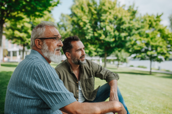 Senior dad and middle-aged son enjoying nature together. Fathers day concept.