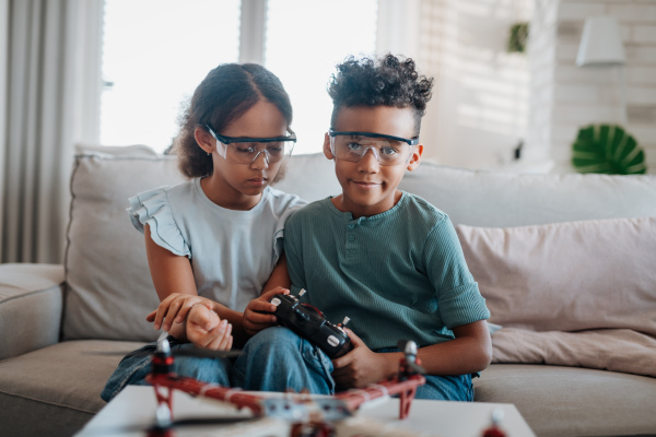 Kids playing with drone at home. Educational robotic kit for children.