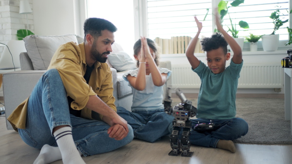 Father teaching kids about STEM, robotics, and discussing technology at home.