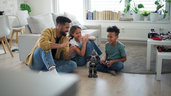 Father teaching kids about STEM, robotics, and discussing technology at home.