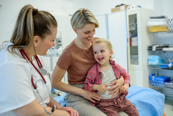 Female pediatrician examing little boy during preventive health check up.