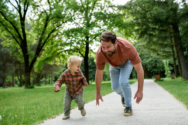 Father lining up to have a running race with his young son.