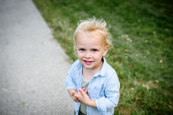 Portrait of a smiling toddler boy in a park