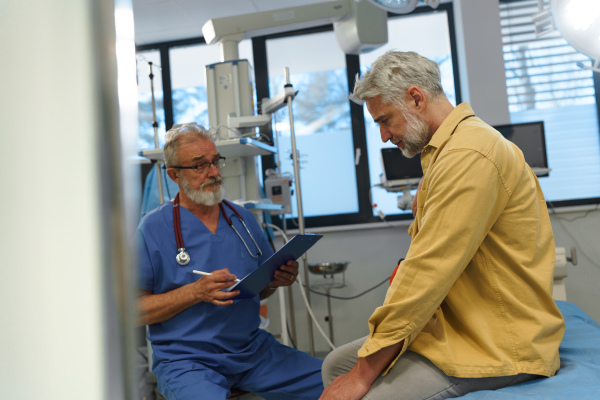 Upset patient on examination table, describing health problems and symptoms to doctor.