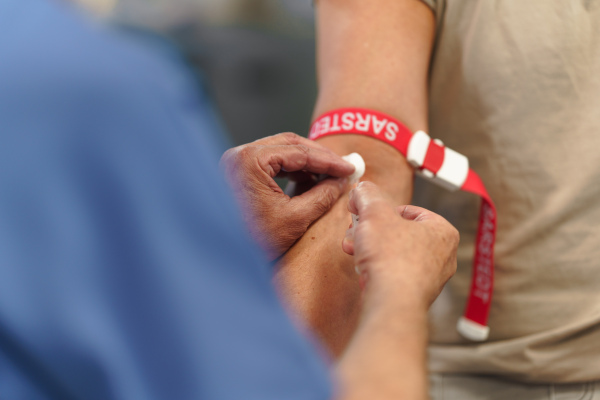 Doctor taking patient's blood pressure using a digital blood pressure monitor.
