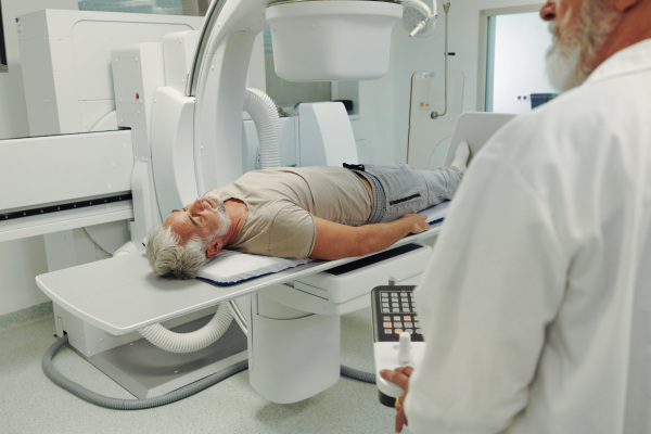 Male patient undergoing CT scan examination in hospital., hospital setting