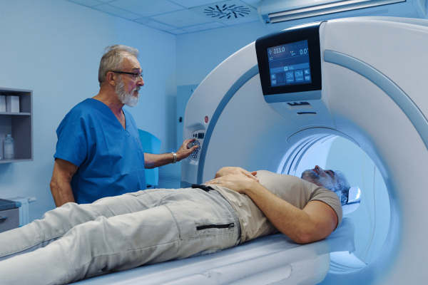 Male patient undergoing CT scan examination in hospital., hospital setting