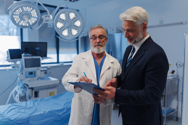 Doctor signing contract with pharmaceutical representative, successful deal.