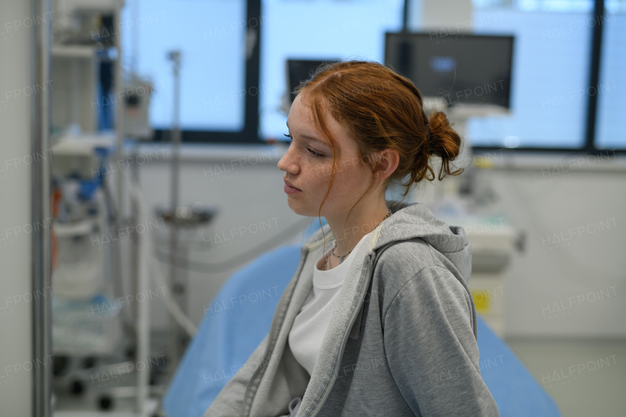Teenage girl waiting for medical examination in hospital. Portrait of adolescent patient.