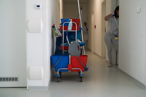 Hospital cleaning cart with supplies in corridor