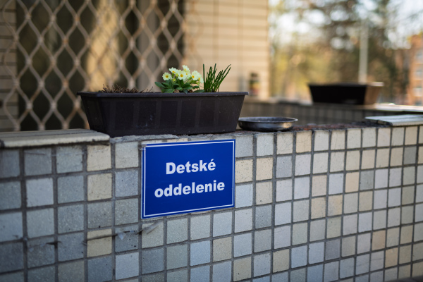 Sign for children's hospital department with flower pot and ashtray