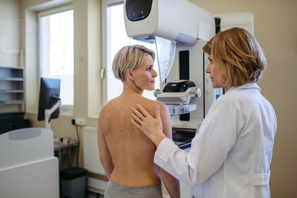 Radiologist comforting patient before mammogram screening. Preventive breast cancer screening.