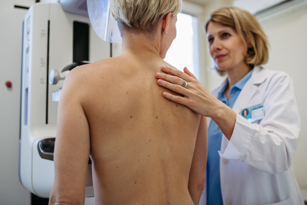Radiologist comforting patient before mammogram screening. Preventive breast cancer screening.