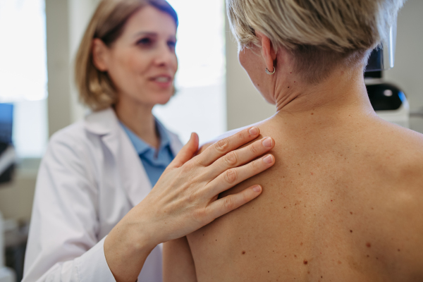 Radiologist comforting patient before mammogram screening. Preventive breast cancer screening.