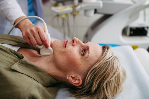 Female patient undergoing thyroid ultrasound examination. Lymp node sonography.