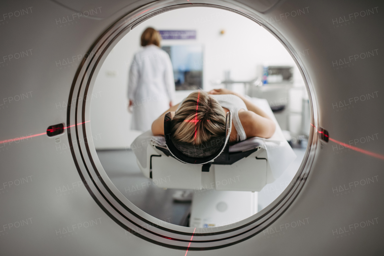 CT scanner view of patient during medical imaging procedure. Woman undergoing MRI scan.