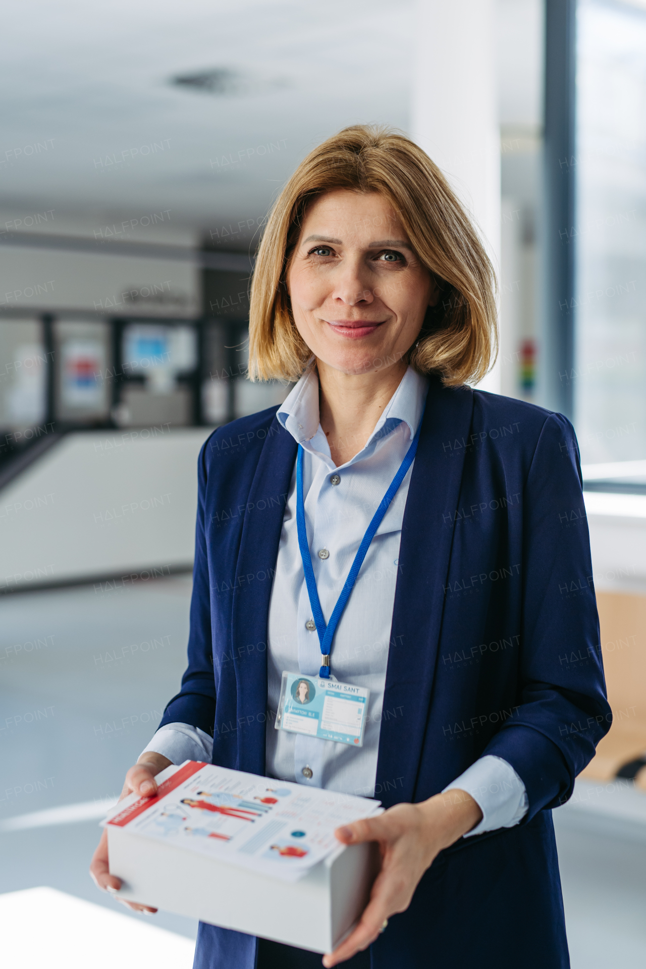 Portrait of female medical sales representative, medical clinic setting.