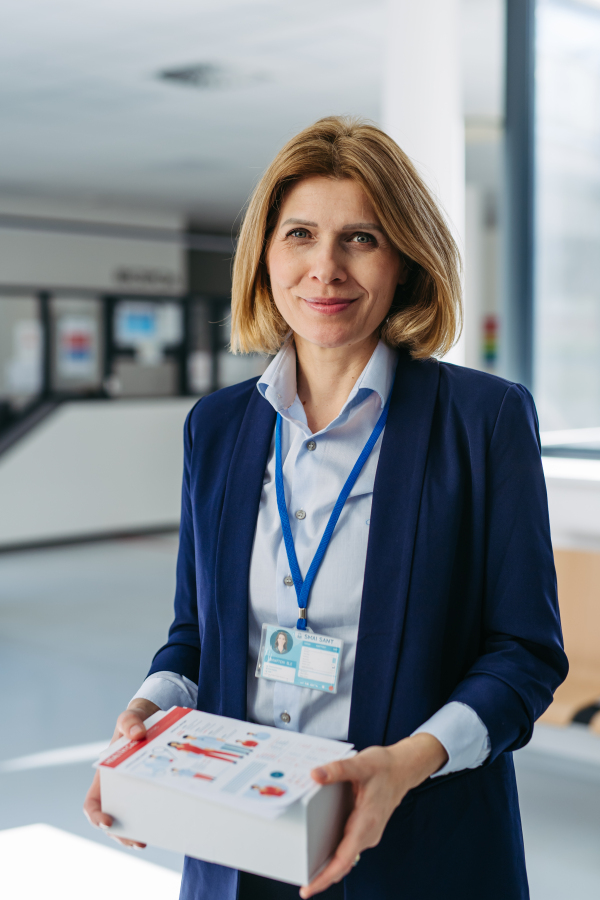Portrait of female medical sales representative, medical clinic setting.