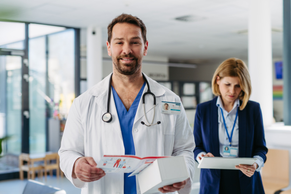 Handsome doctor and pharmaceutical rep meeting to discuss new drugs, medications.