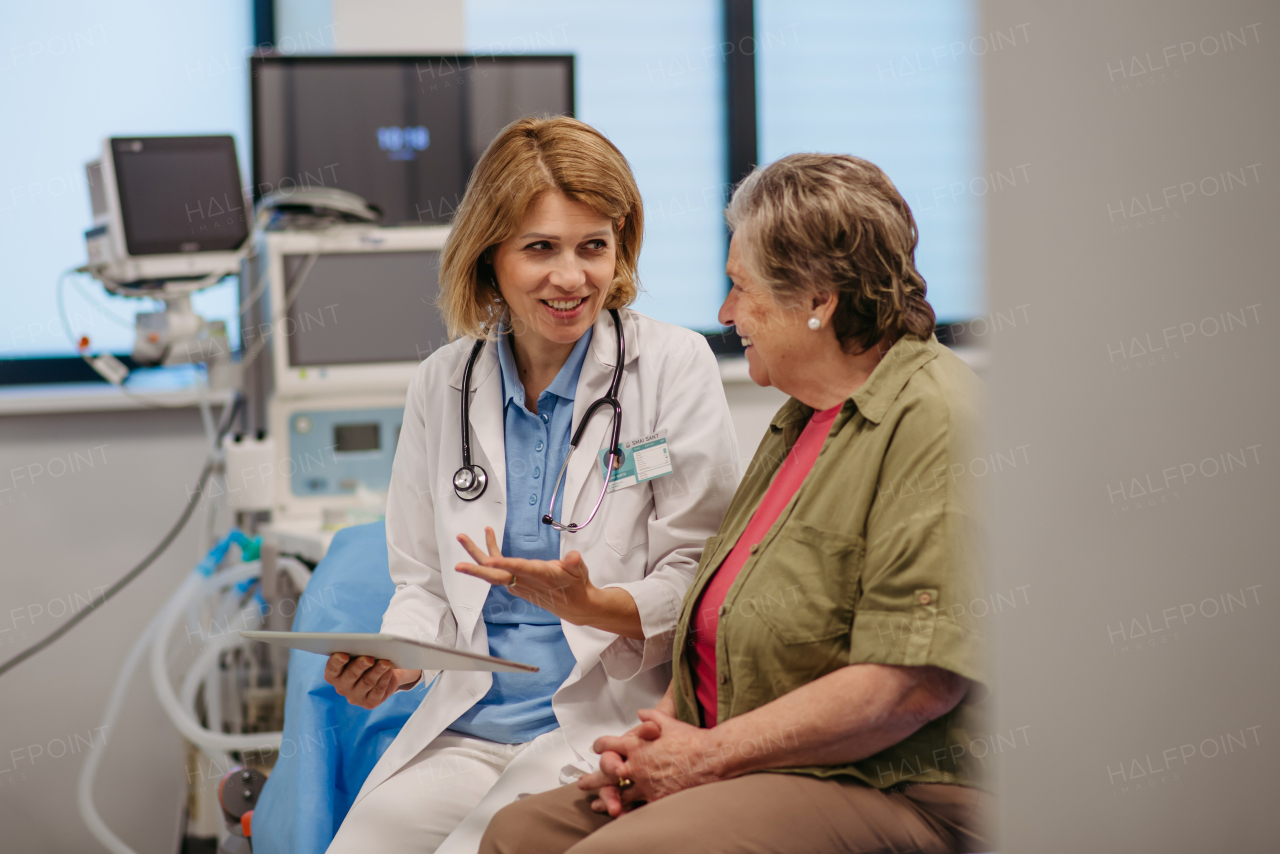 Geriatrician talking with senior patient during check-up. Medical consultation.