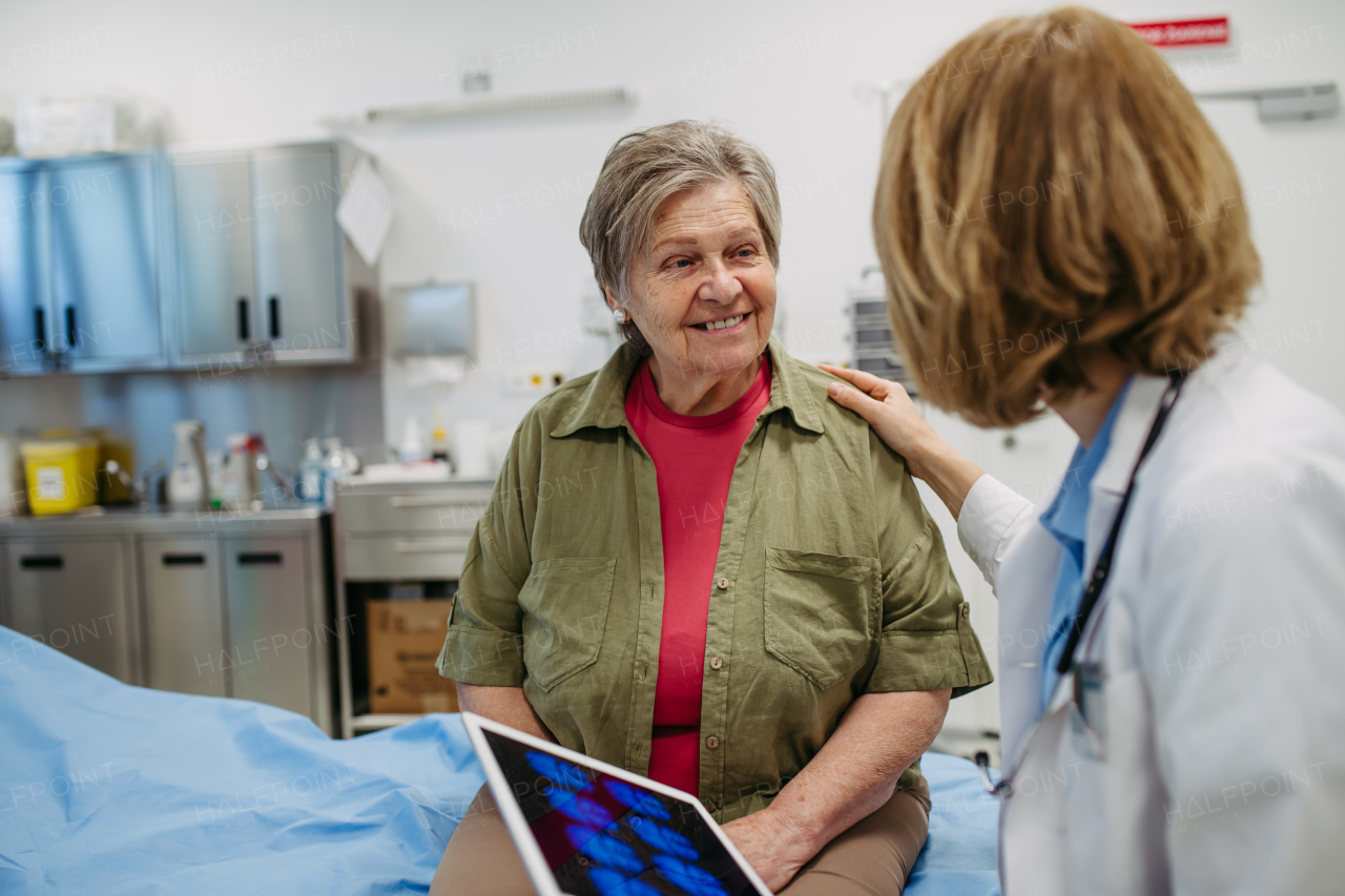 Geriatrician explaining test results to senior patient during check-up. Medical consultation.