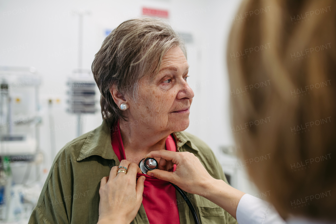 Elderly patient having heart checked by geriatric doctor. Health exam for elderly woman.