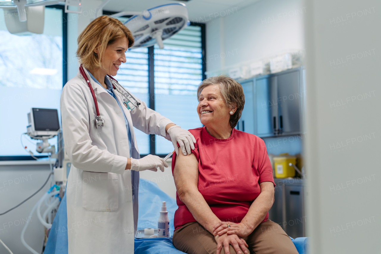 Elderly patient being vaccinated by doctor. Preventive care.