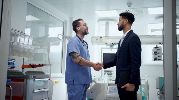 New manager introduces himself to the medical staff. Modern clinic, hospital setting.