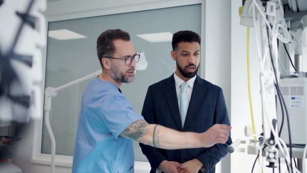 A clinic director showing new doctor around the hospital workplace.