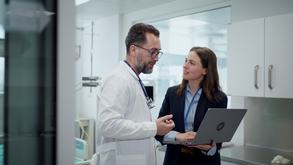 A female hospital manager and doctor, hospital setting.