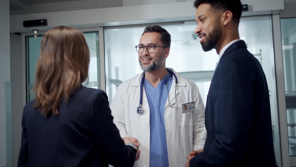 New managers introduces themselves to the medical staff. Modern clinic, hospital setting.
