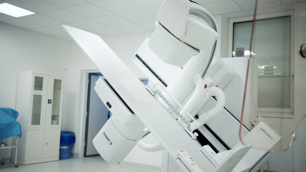 Modern tilting fluoroscopy wall unit in diagnostic imaging room