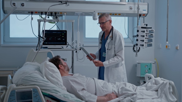 A doctor examining the patient in bed. Medical procedure.