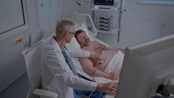 A doctor examining the patient in bed. Medical procedure.