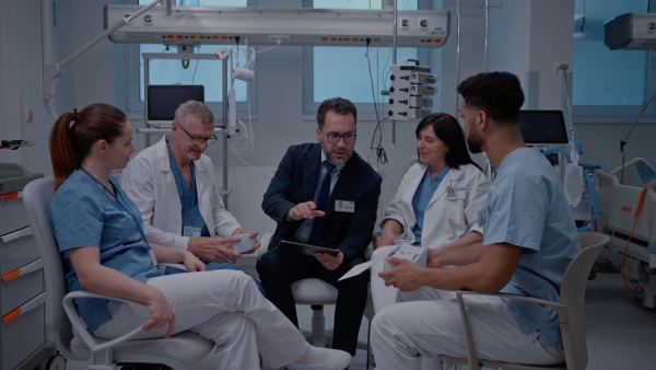 A pharmaceutical sales respresentative showing medical satff new medications. Group presentation in hospital setting.