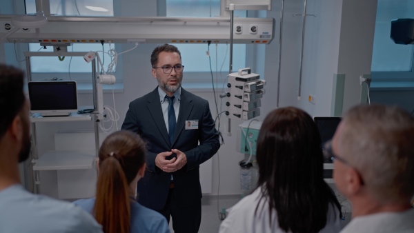 A pharmaceutical sales respresentative showing medical satff new medications. Group presentation in hospital setting.