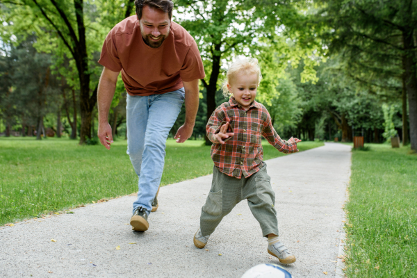 Father lining up to have a running race with his young son.
